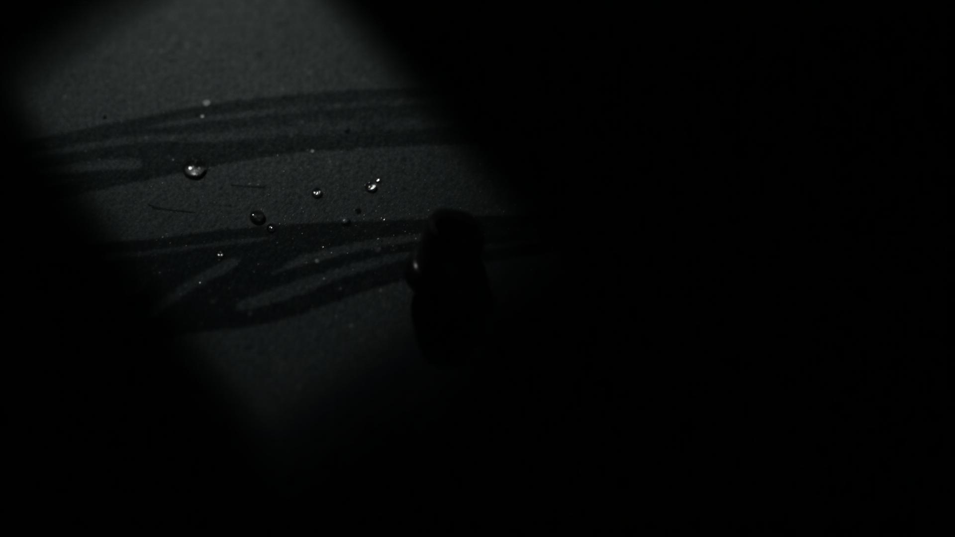 Ink on textured paper catching faint light